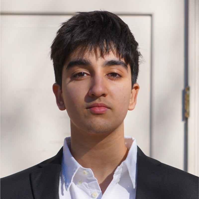 Portrait of Headshot of a young man against a white door