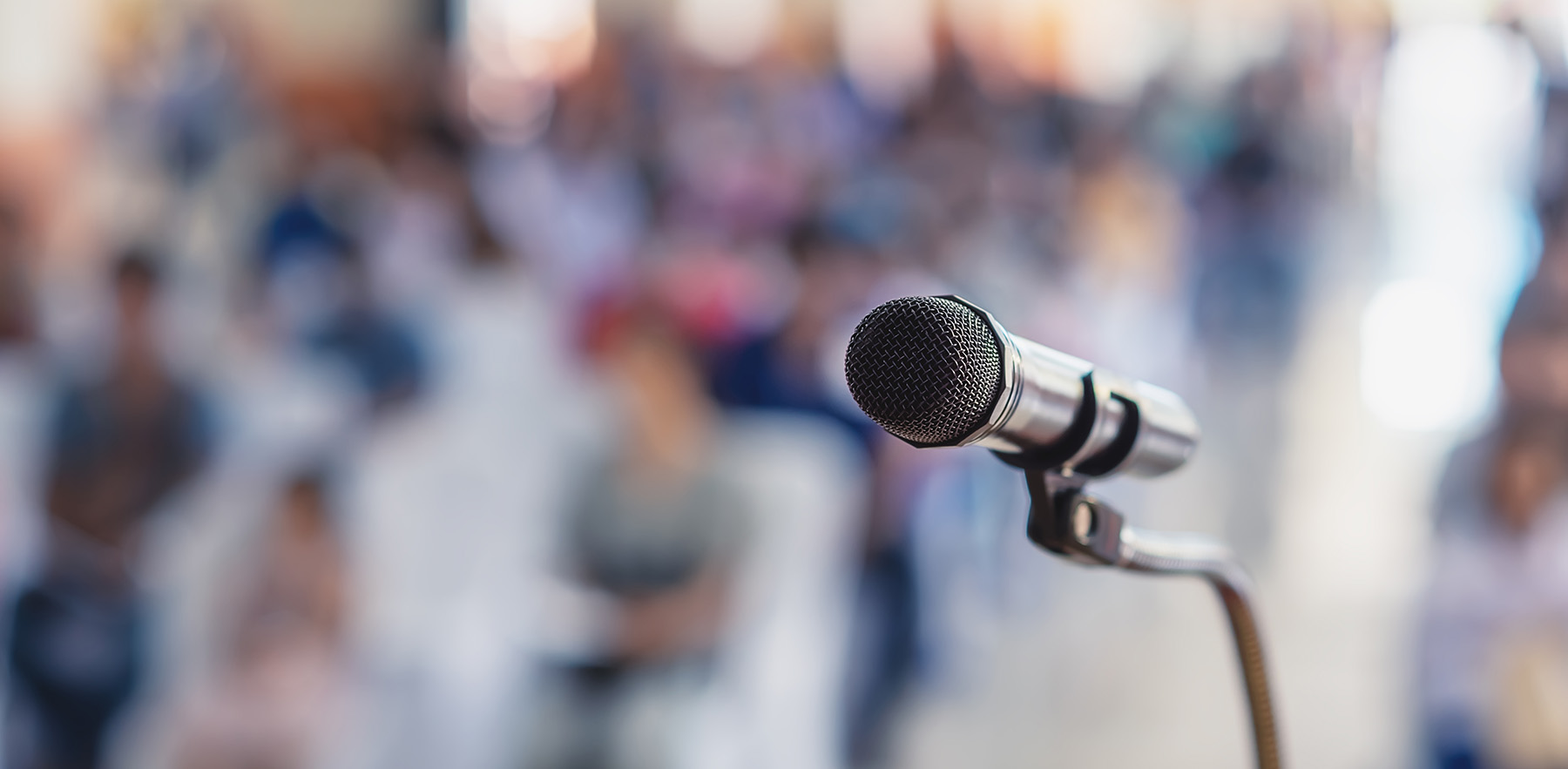 Soft focus of head microphone on stage of meeting